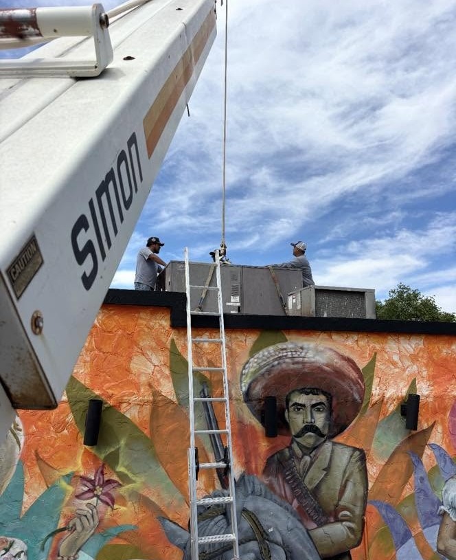 A-1 technicians installing a rooftop commercial unit at a local business